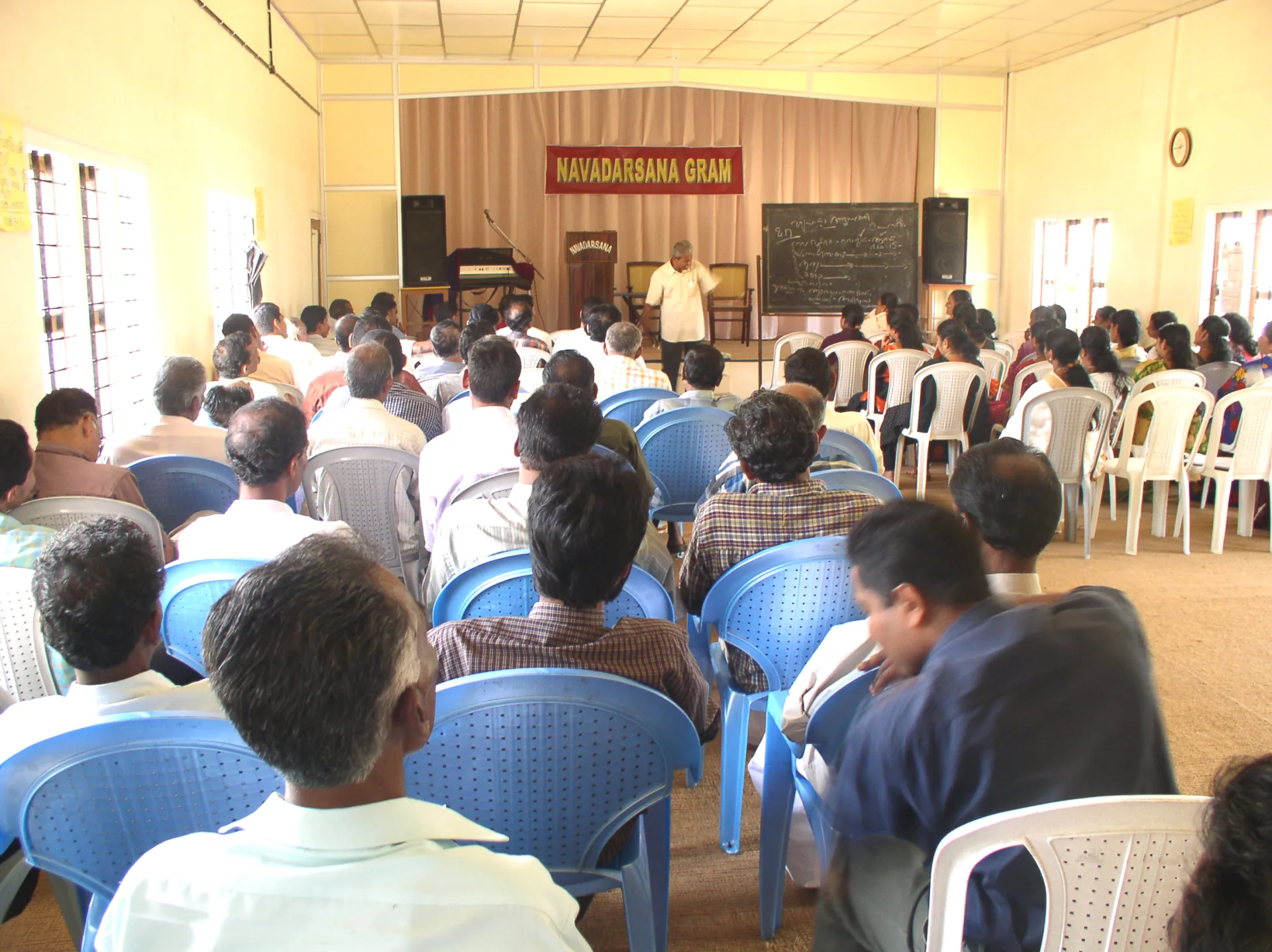 Participants attending a community awareness session at Navadarsanagram
